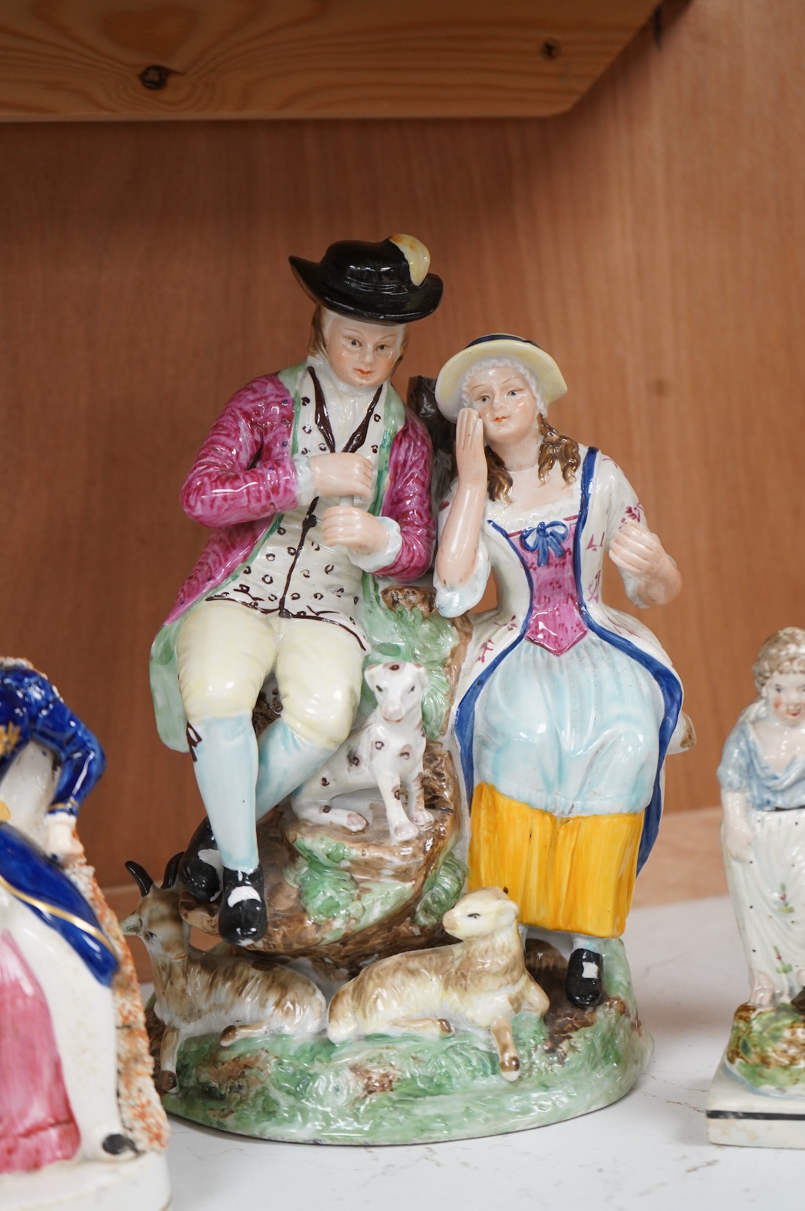 A Ralph Wood style group and three Staffordshire figures, largest 26cm high